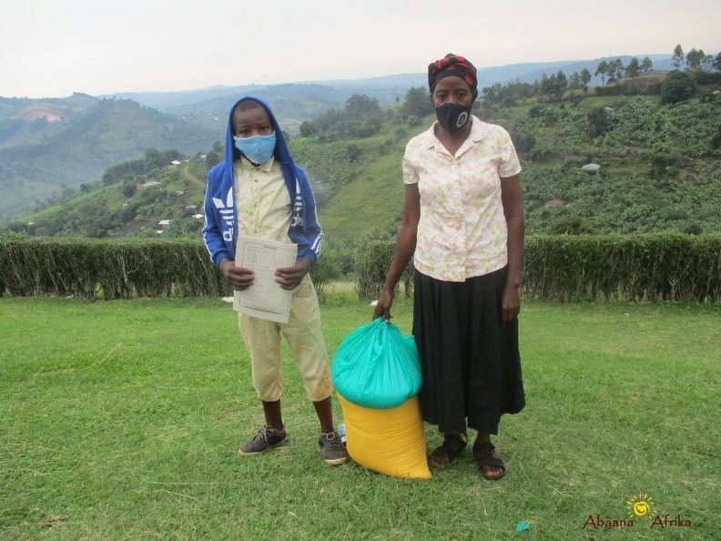 Byaruhanga Nicolus family with their food relief (1).JPG