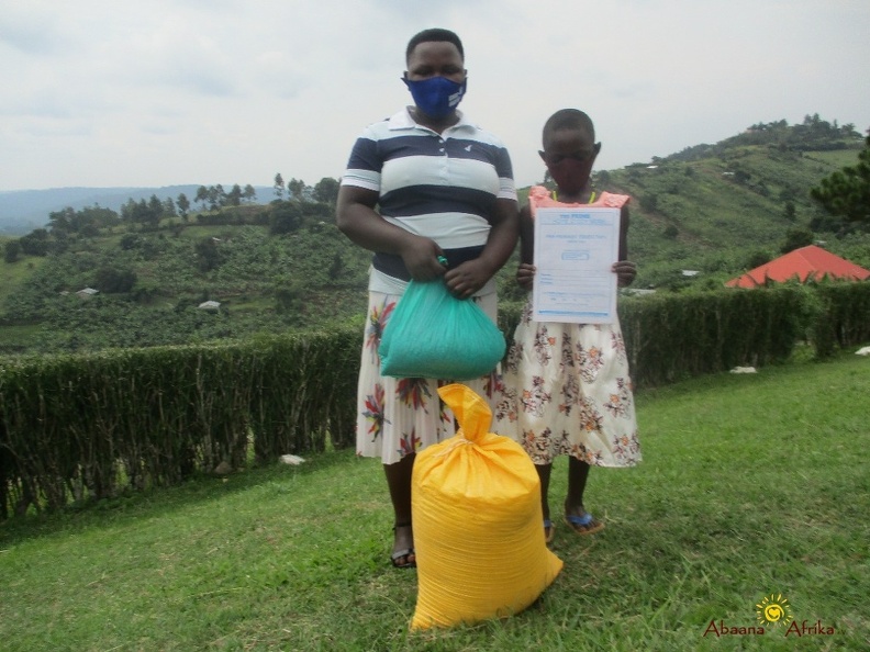 Kabahuma Rosette's family with their food relief (2).JPG