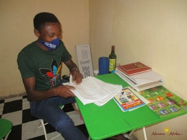 Teacher Allelua Christopher marking home study work (4)