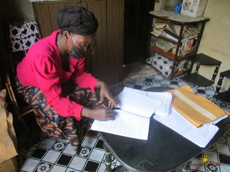 Teacher Kabagambe Lillian marking home study work (4).JPG