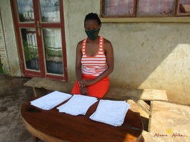 Teacher Mawino Caroline marking her pupils home study work (3)