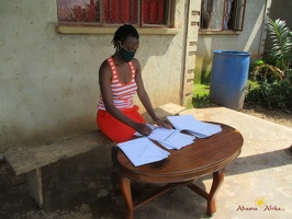 Teacher Mawino Caroline marking her pupils home study work (7)